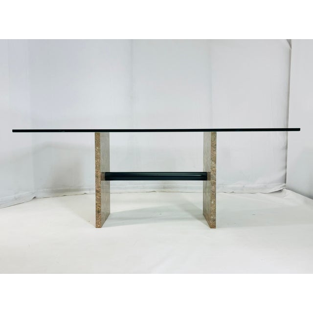 Mid-Century modern dining room table designed and manufactured in the 1970's in Italy. The table has a marble base with a...