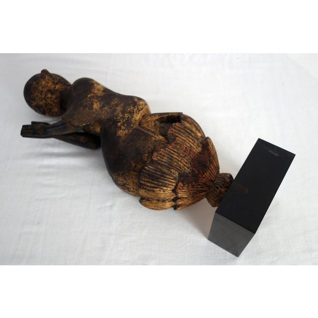 Statuette in patinated and gilded carved wood representing a monk or worshiper in prayer, Burma, 20th century. Kneeling in...