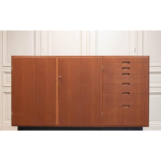 A refined and functional mid-century modern teak cabinet, designed by Kurt Karlsson and produced by August Löfvings...