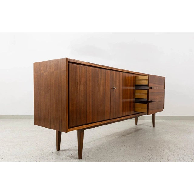 Sideboard in walnut veneer Type 2009, manufactured by Swarzędzkie Fabryki Mebli in Poland in 1970s. A distinctive feature...