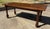 Lovely dark French country dining table with solid top and turned legs.