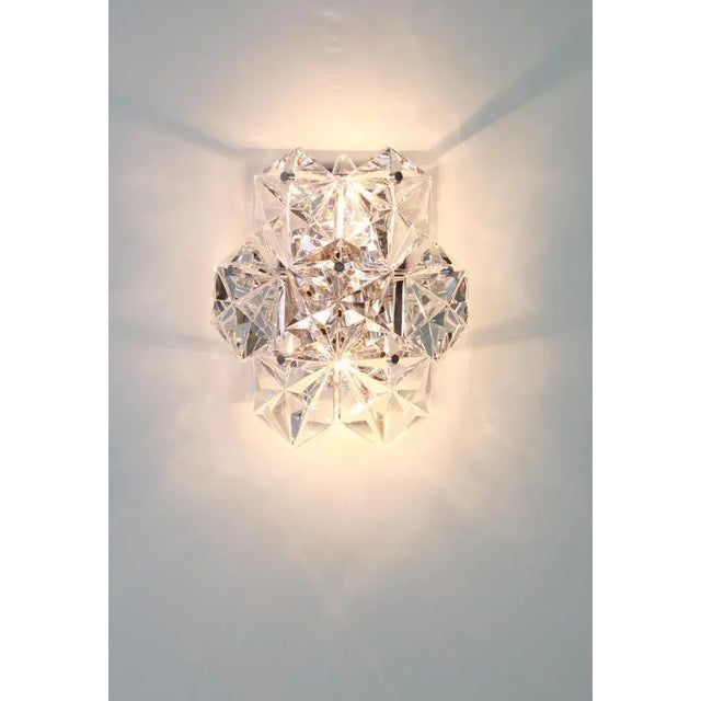 A stunning pair of chrome sconces with crystal glasses, made by kinkeldey, germany, circa 1970-1979. It’s composed of 7...