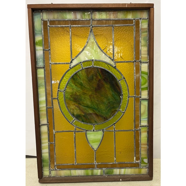 Beautiful handmade old stained glass panel in a wood frame. Can you hung in front of a window or installed. Great colors...