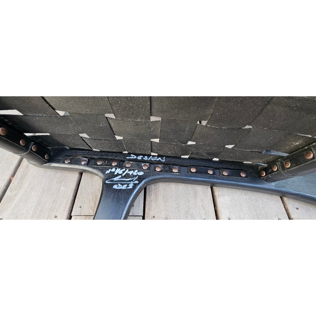 Pair of "Hollywood" armchairs in black leather and black-stained mahogany. Made in Italy by Ode Design. Signed and...