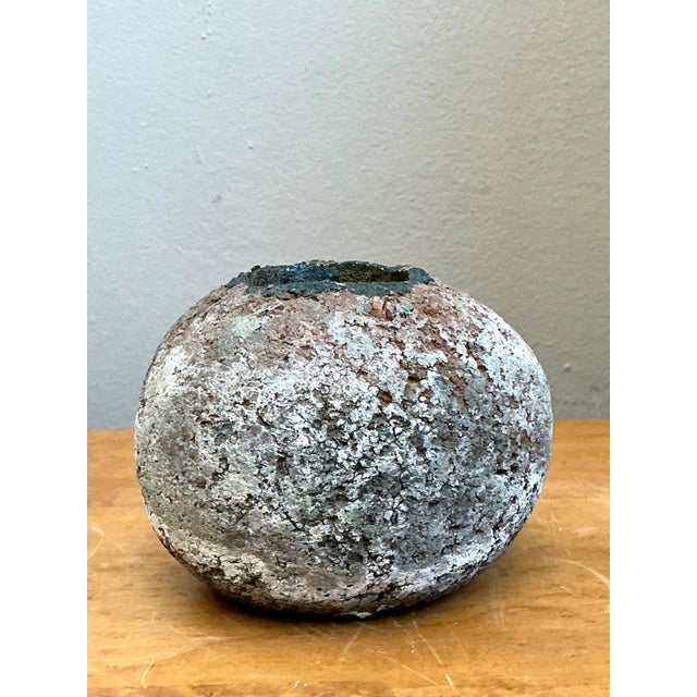 This vintage handcrafted earthenware vessel embodies the timeless appeal of artisan ceramics with its organic silhouette...