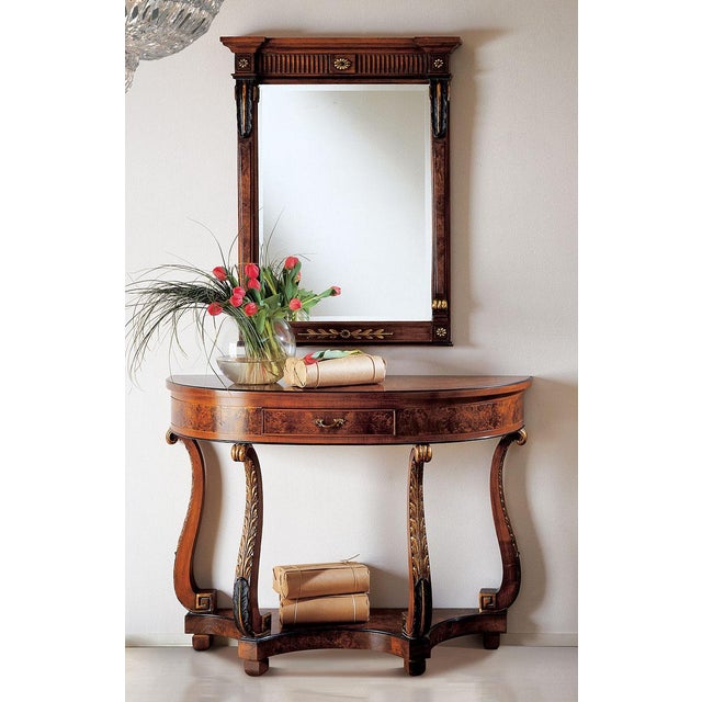 Handcrafted in Italy, this console table features walnut burl veneers, a curved front, and a single drawer with brass...