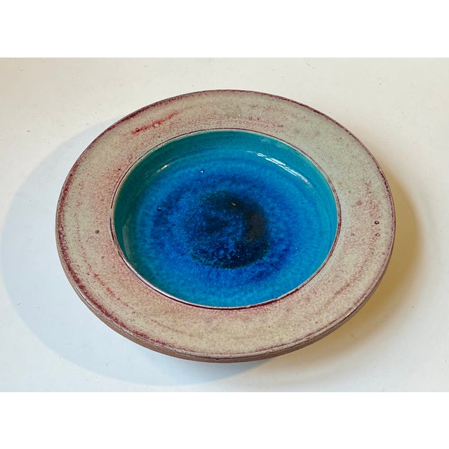 Sea of glaze dish or centerpiece bowl' decorated with blue center glazes and executed by the danish ceramist nils kähler...