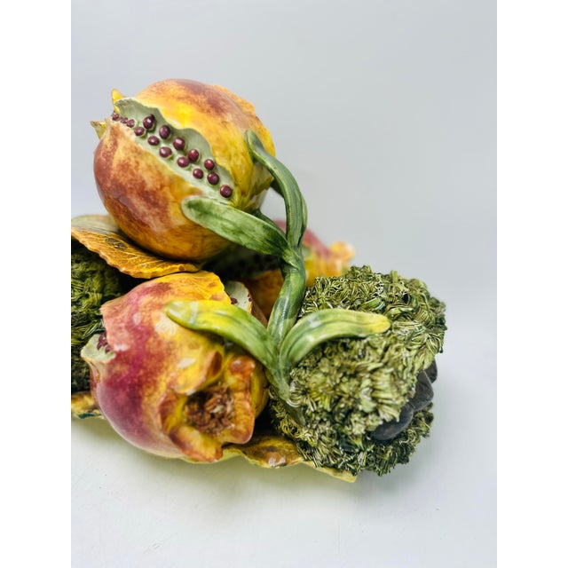 This is a vintage Italian majolica ceramic fruit centerpiece. Design • A sculptural arrangement of two split pomegranates...