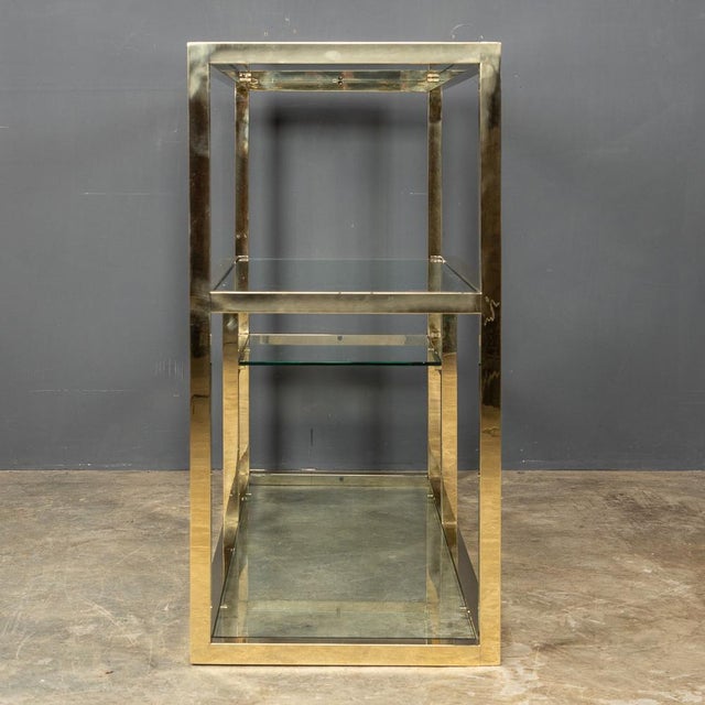 Stylish 20th Century smart four tier etegere with glass shelves of various sizes in a sturdy highly polished brass frame,...
