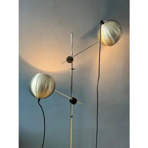Aluminium space age eyeball floor lamp with double swing arms. The swivel arms carrying the shades can move up and down...