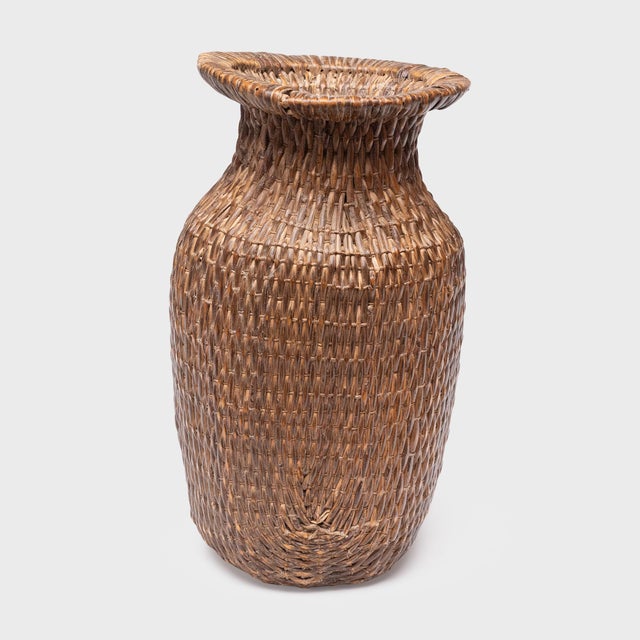 This antique Chinese basket is beautifully woven of river reeds and cord to the sculptural shape of a phoenix-tail vase...