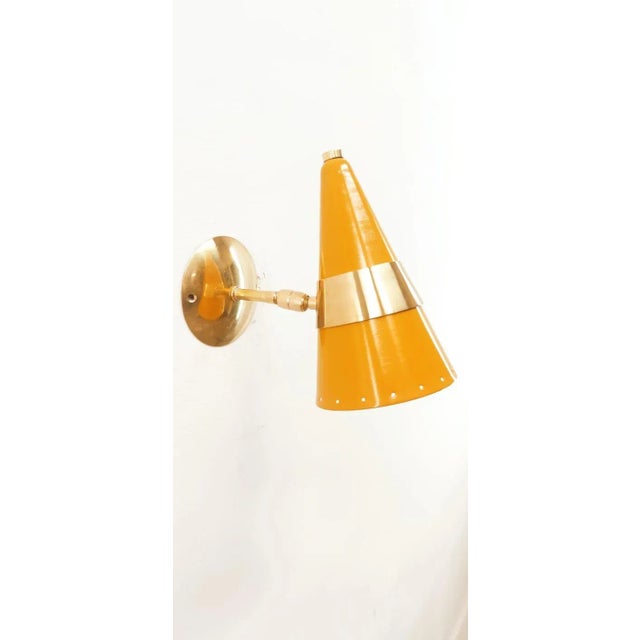Yellow & Brass Adjustable Cone Sconce, in Very Good conditions. Designed 1970 to 1979 Up to 250V (Europe/UK Standard).The...