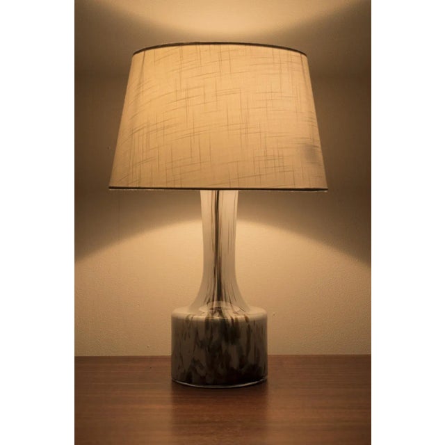 Beautiful vintage holmegaard table lamp from denmark, 1970s. The lamp has a wonderful white glass base with white lamp...