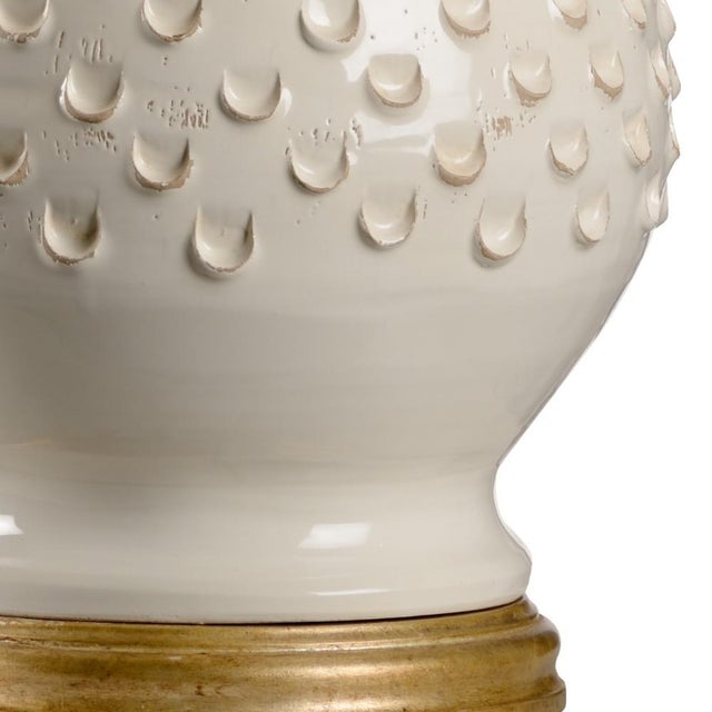 The cream glazed finish, shapely body and hand textured design pattern of the italian ceramic create an alluring table...