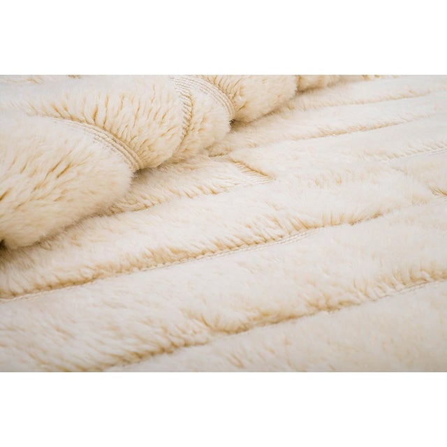 Monochrome depth, built layer by layer. Subtle geometric shapes stack and overlap across this piece in soft, tonal cream,...