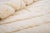 Monochrome depth, built layer by layer. Subtle geometric shapes stack and overlap across this piece in soft, tonal cream,...