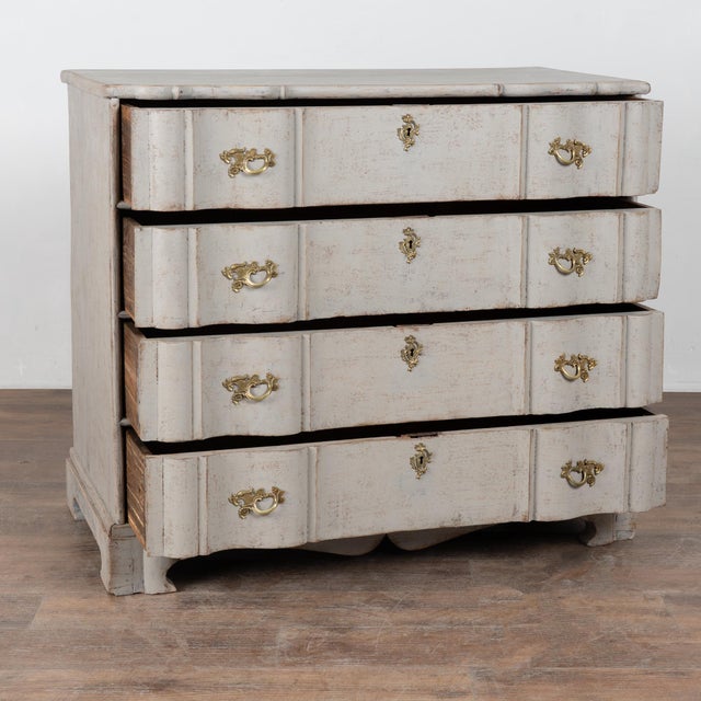 Large 19th-century Rococo-style chest of four drawers with a serpentine oak front and pine sides and drawer bottoms,...
