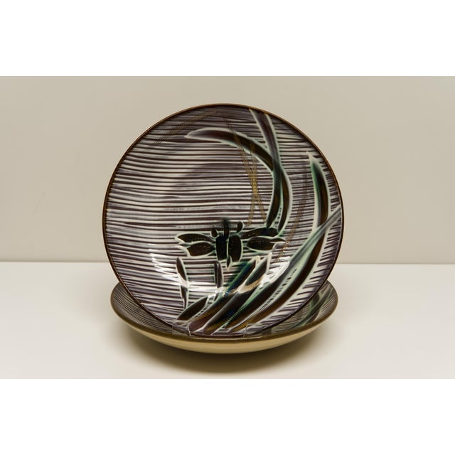 A pair to dinner plates featuring iris flowers motif. Manufactured by Ucago circa 1950s in occupied Japan. Marked on the...