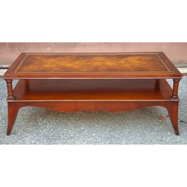 English Regency Style Tooled Leather Inset Mahogany Two-Tier Coffee Table, Circa 1940s Measures 46" in width and 23.5" in...