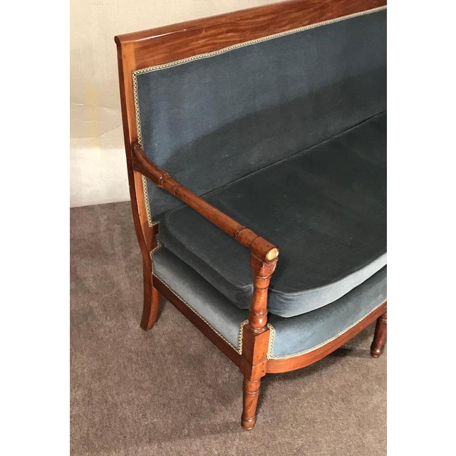 Step back in time to the opulent era of 19th-century France with the exquisite Elegant Empire Settee, crafted in 1810....