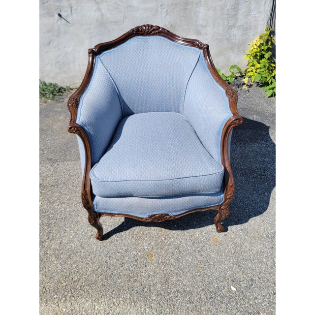 The 1930 Club Living Room Chair is a fully assembled, antique chair in a solid sky blue color. This indoor chair,...