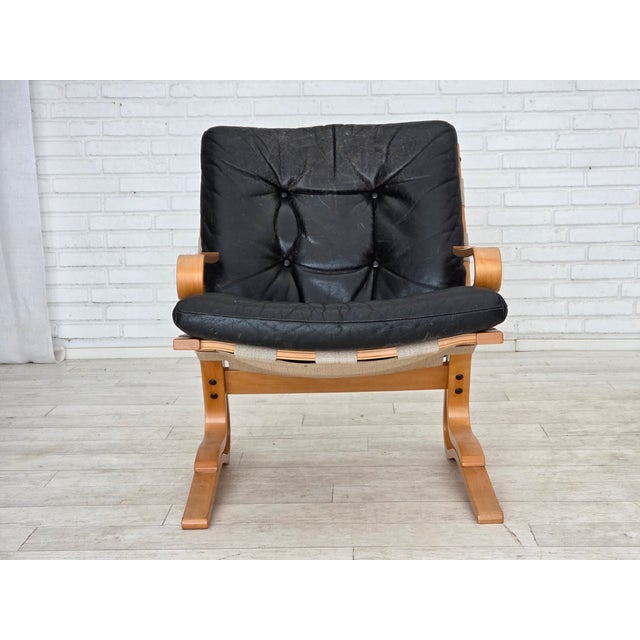 1970s, Norwegian design. Armchair model "Kengu". Original black leather with patina, bent wood, canvas. Original good...