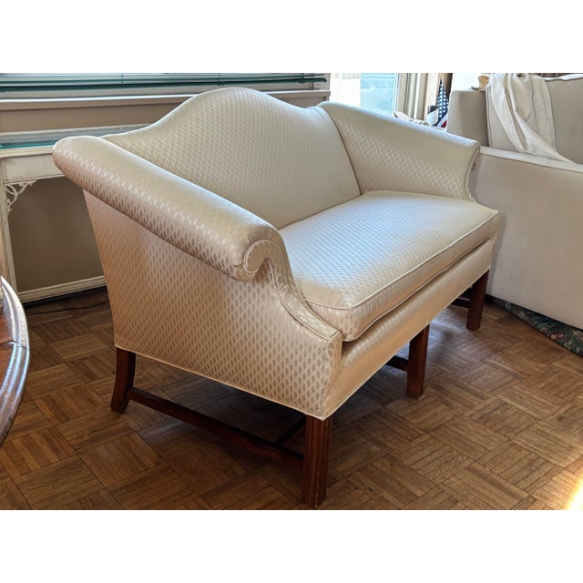 Well-proportioned camelback loveseat featuring graceful scroll arms and a classic, timeless silhouette. This handsome...