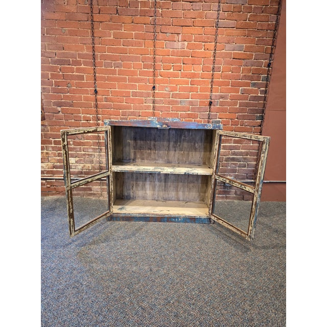 Add a layer of authentic history and perfectly imperfect charm to your home with this solid wood display cabinet....