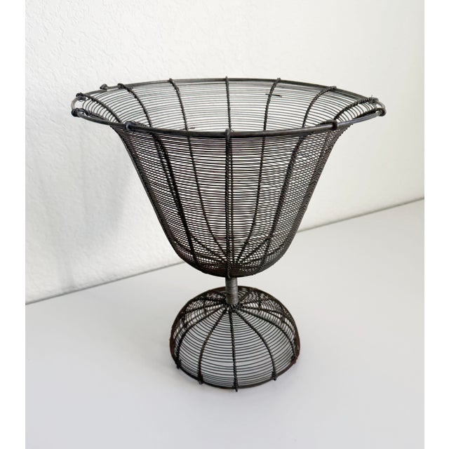 A charming and rustic wire planter or compote with a pedestal base and an urn-style basket. French-made, circa late 1800s...