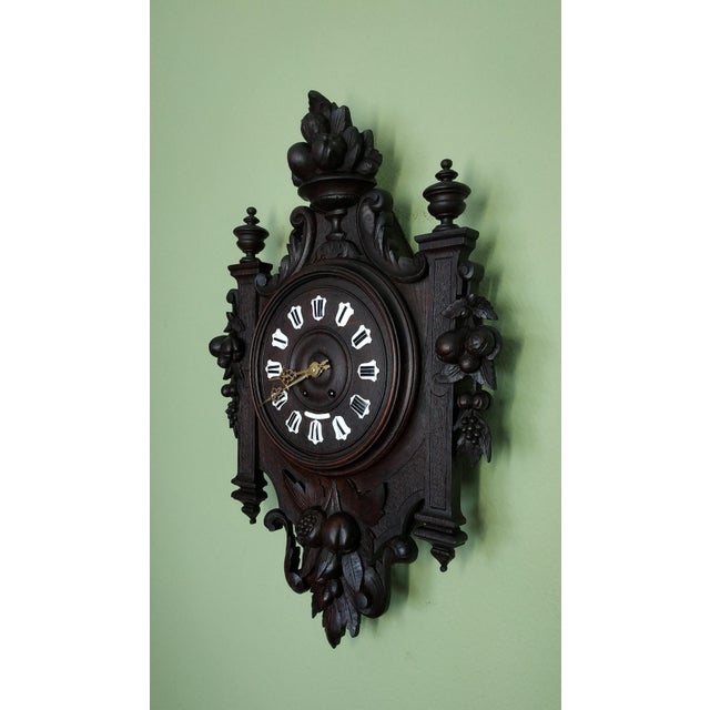 1840-1860 Grand French carved wooden cartel and enameled cartridges Rare, hand-carved wooden cartel clock with a wooden...
