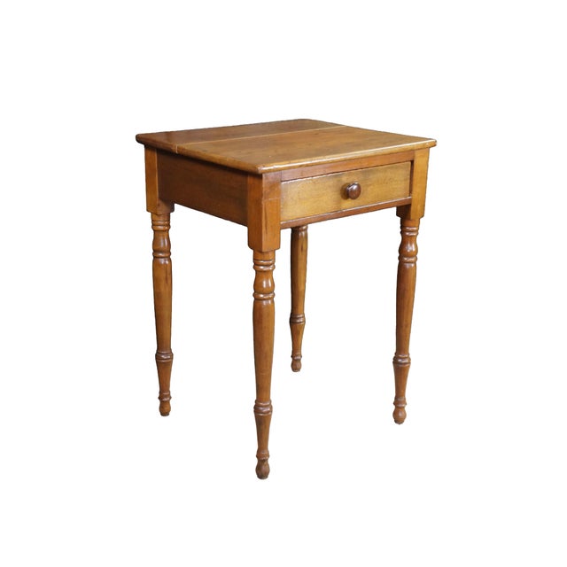 A beautiful antique early American early 19th century cherry side table. Features a rectangular form with hand dovetailed...