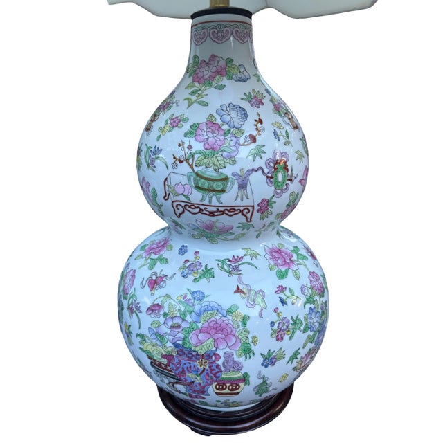 Exceptional pair of vintage Chinese porcelain table lamps in a classic double-gourd form, richly decorated in a colorful...