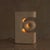 A French table lamp from the 1970s, attributed to Albert Tormos and hand-carved from solid limestone. The monolithic form...