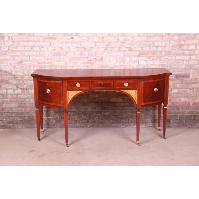 A rare and exceptional Sheraton bow-fronted mahogany sideboard from the exclusive Stately Homes Collection by Baker...