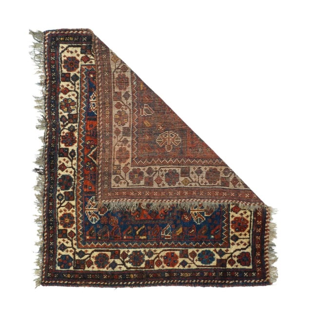 This moderately/coarse knotted small square nomadic scatter from SW Persis presents a tall, stepped dark blue, red and...