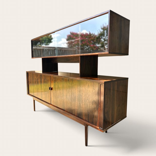 Elegant credenza and top hutch designed and manufactured by Peter Løvig Nielsen in Denmark. Featuring a brazilian rose...