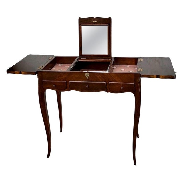 Elegant French Louis XV–style vanity table, crafted in richly toned wood and distinguished by its refined cabriole legs...