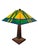 A beautifully crafted licensed Thomas Kinkade “Painter of Light” stained glass table lamp featuring a striking Prairie...