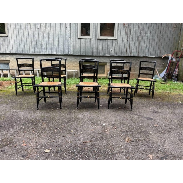 Hitchcock Style Black Painted Stenciled Side Chairs with Rush Woven Seats Each chair features a black painted frame...
