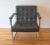 This is a mid century modern Milo Baughman style arm lounge chair. It is upholstered in sleek black tufted naugahyde, with...