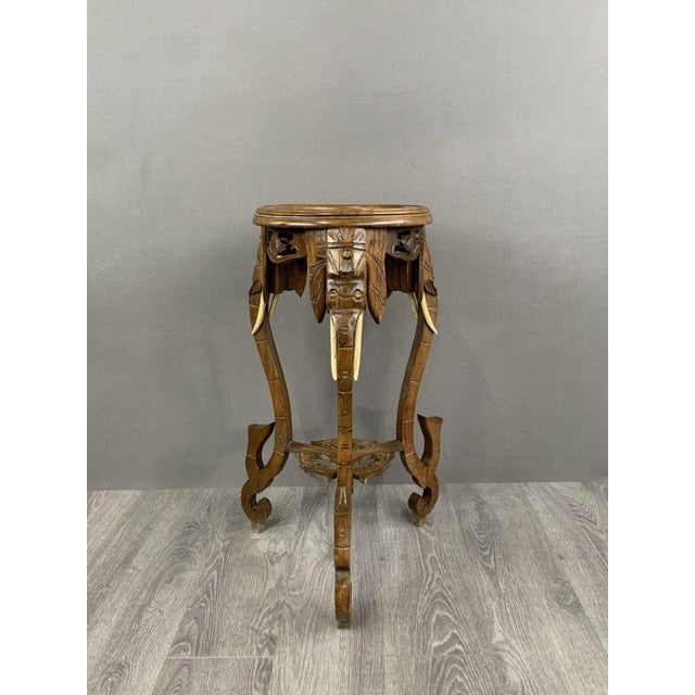 Carved Side Table with Elephant Heads, Early 20th Century : This exceptional side table, dating from the early 20th...