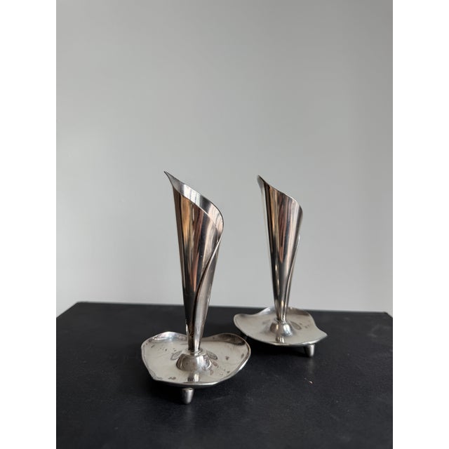 Beautiful pair of Danish Modern silverplate candlesticks By Hans Jensen Denmark, 1960s Each measures: 2.5"W x 2.5"D x 4.5"H.