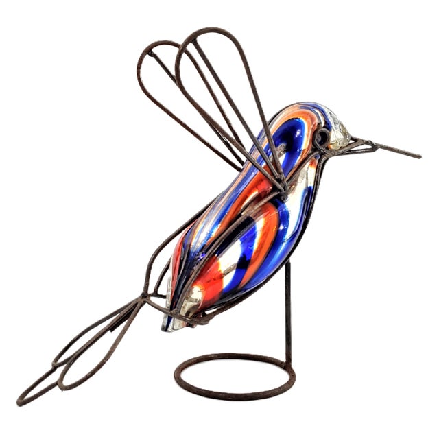 Offering a vintage blue and red mercury glass sculpture of a hummingbird in flight, encased in a welded rod support. circa...