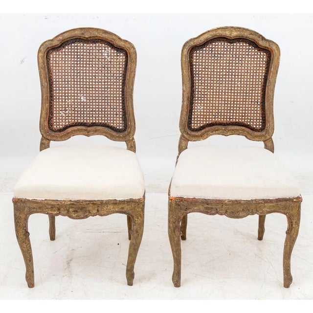 Pair of French Provincial Baroque Painted Carved Wood Side Chairs, 18th century, with cane backing and gray upholstered...