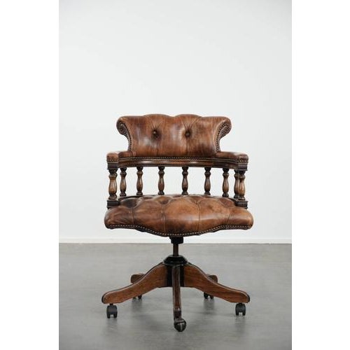 We are offering this stunning, elegant, and classic cognac-colored cowhide Chesterfield office chair/captain's chair in...