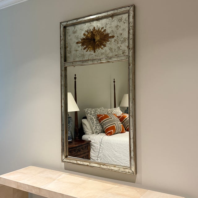 Chelsea House Halcyon Mirror A clear mirror framed in antique silver leaf wood with gold medallion. Designed by Jamie...