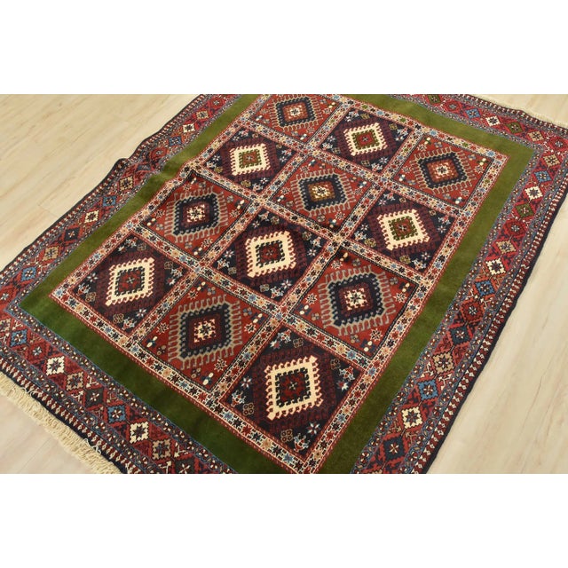 This authentic vintage, tribal, geometric Yalameh rug is hand-knotted with an all-wool pile on a wool foundation. This rug...