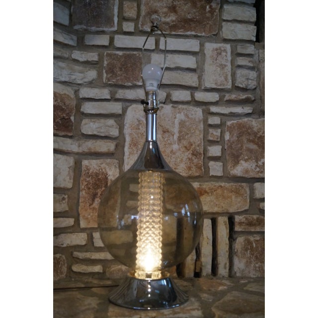 A 1960s modernist chrome and smoked glass lamp which features an inner light which can be turned on with or without the...