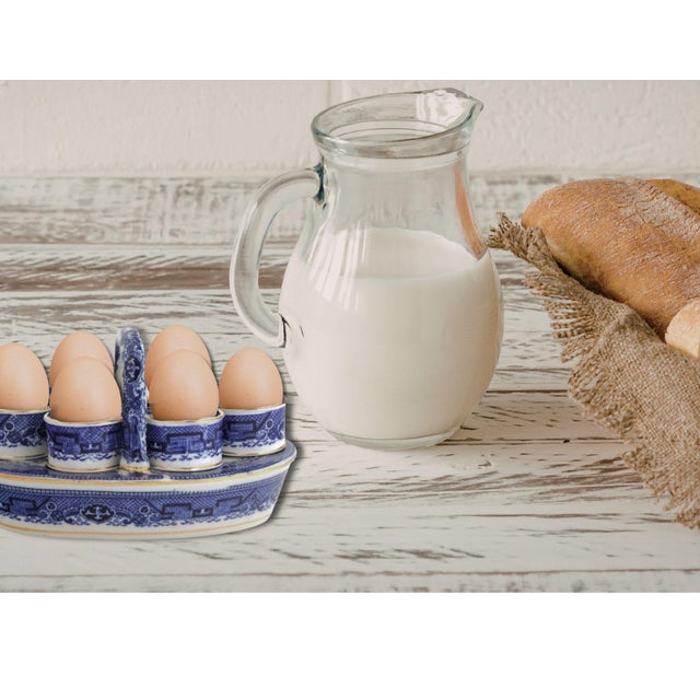 Circa 1880 English Willow pattern porcelain egg cup set including six pedestal egg cups and matching handled stand....