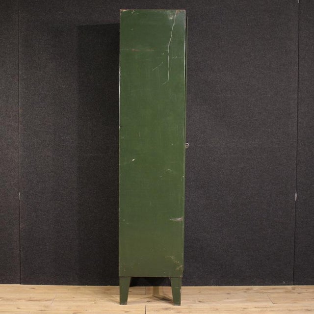 Italian cabinet from the 1970s. An industrial-style piece made of green lacquered metal. This single-door unit is...